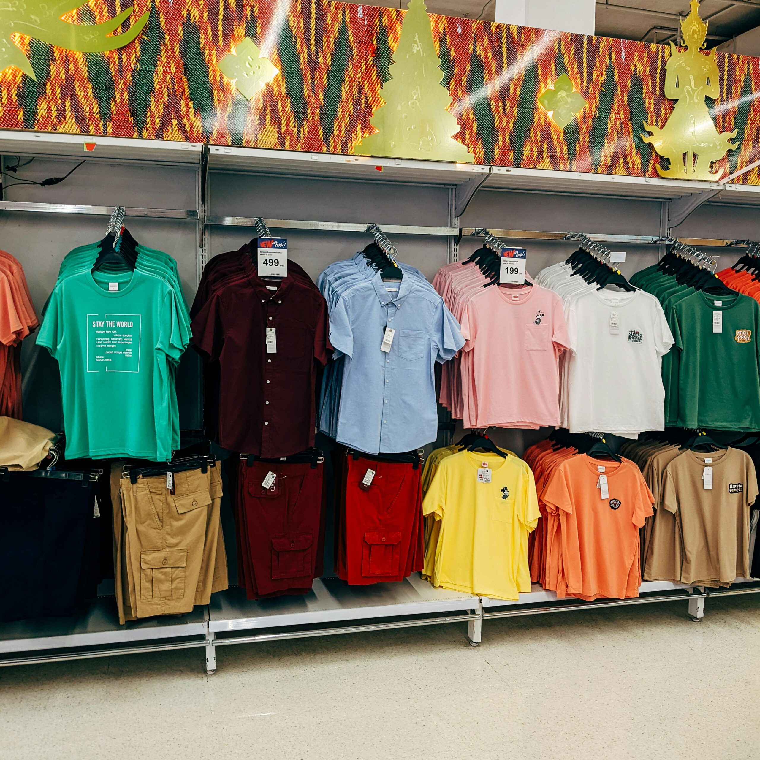 Vibrant assortment of casual shirts neatly arranged in a retail store setting.