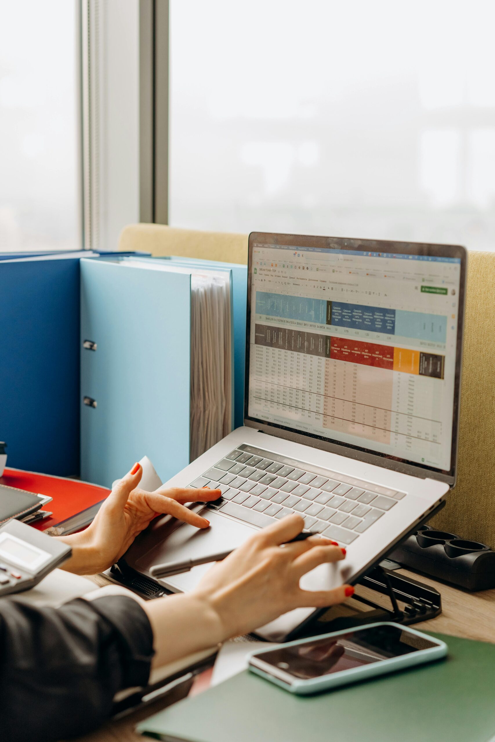 Business workspace with folders and laptop showing analytics screen. Ideal for tech and work themes.